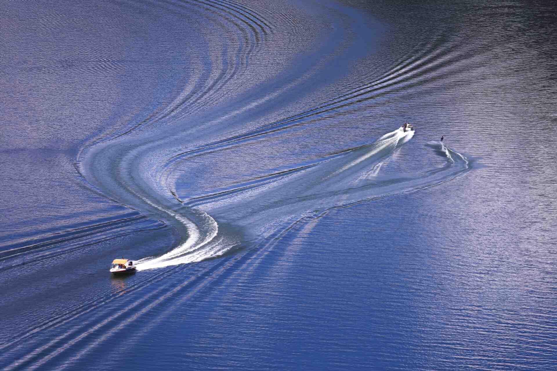 A Nitra and Nor-Tech boat passing eachother on the waters of Fort Myers