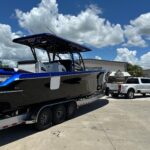 Offshore Center Console Boat on Triple-Axle Trailer with Quad Outboards