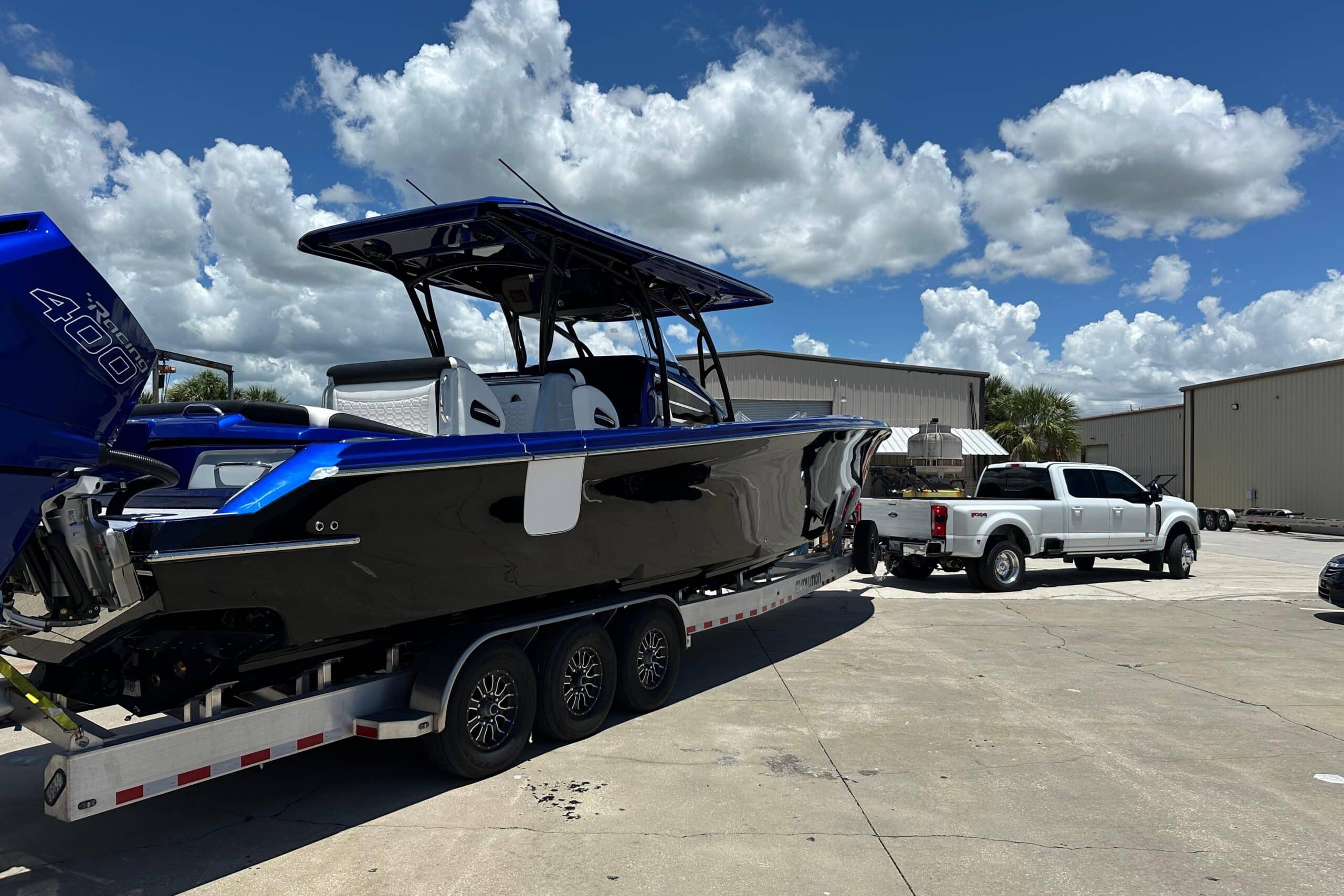 Offshore Center Console Boat on Triple-Axle Trailer with Quad Outboards