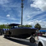 Black and Blue 2025 Nor-Tech 390 Sport Power Being Hauled