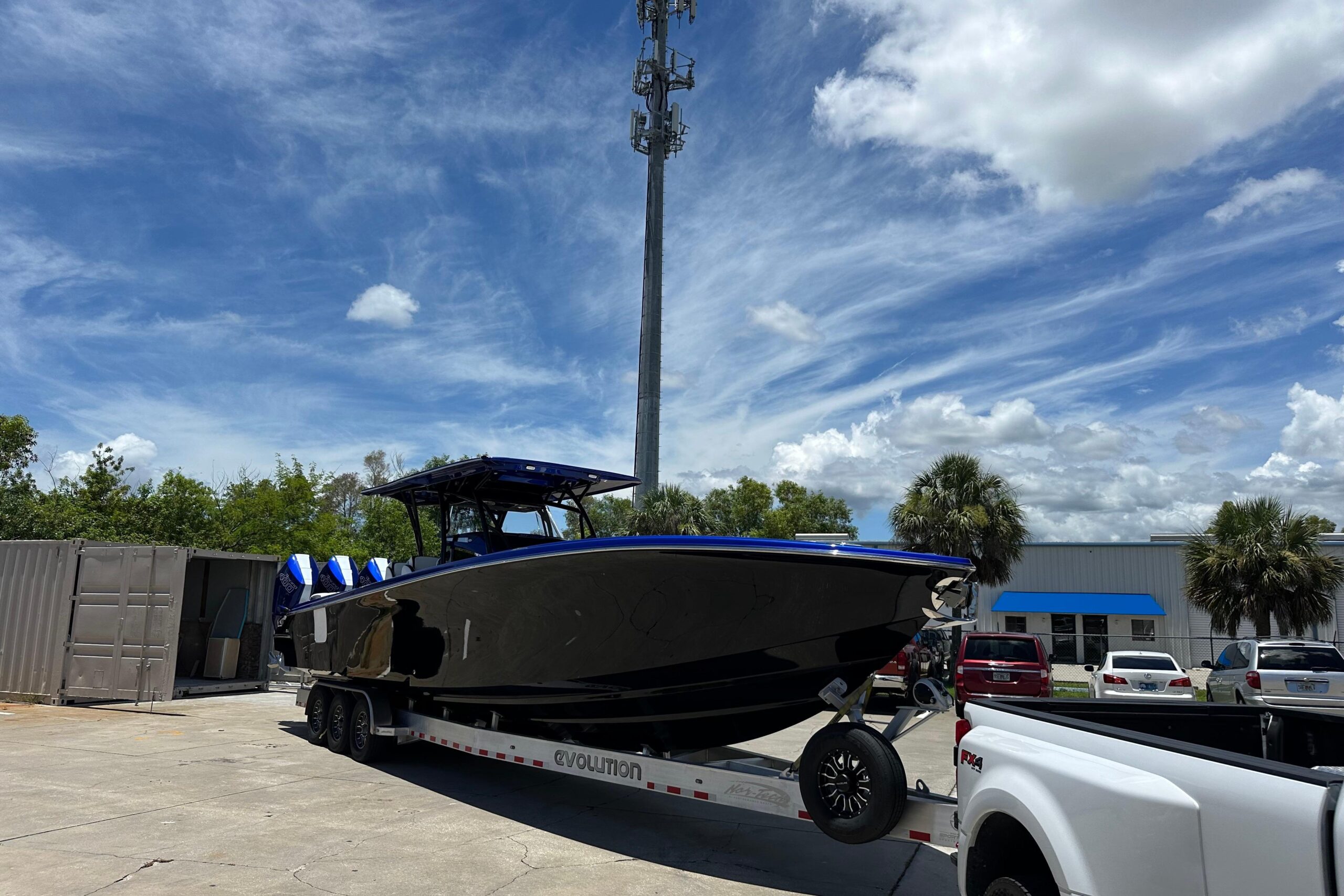 Black and Blue 2025 Nor-Tech 390 Sport Power Being Hauled