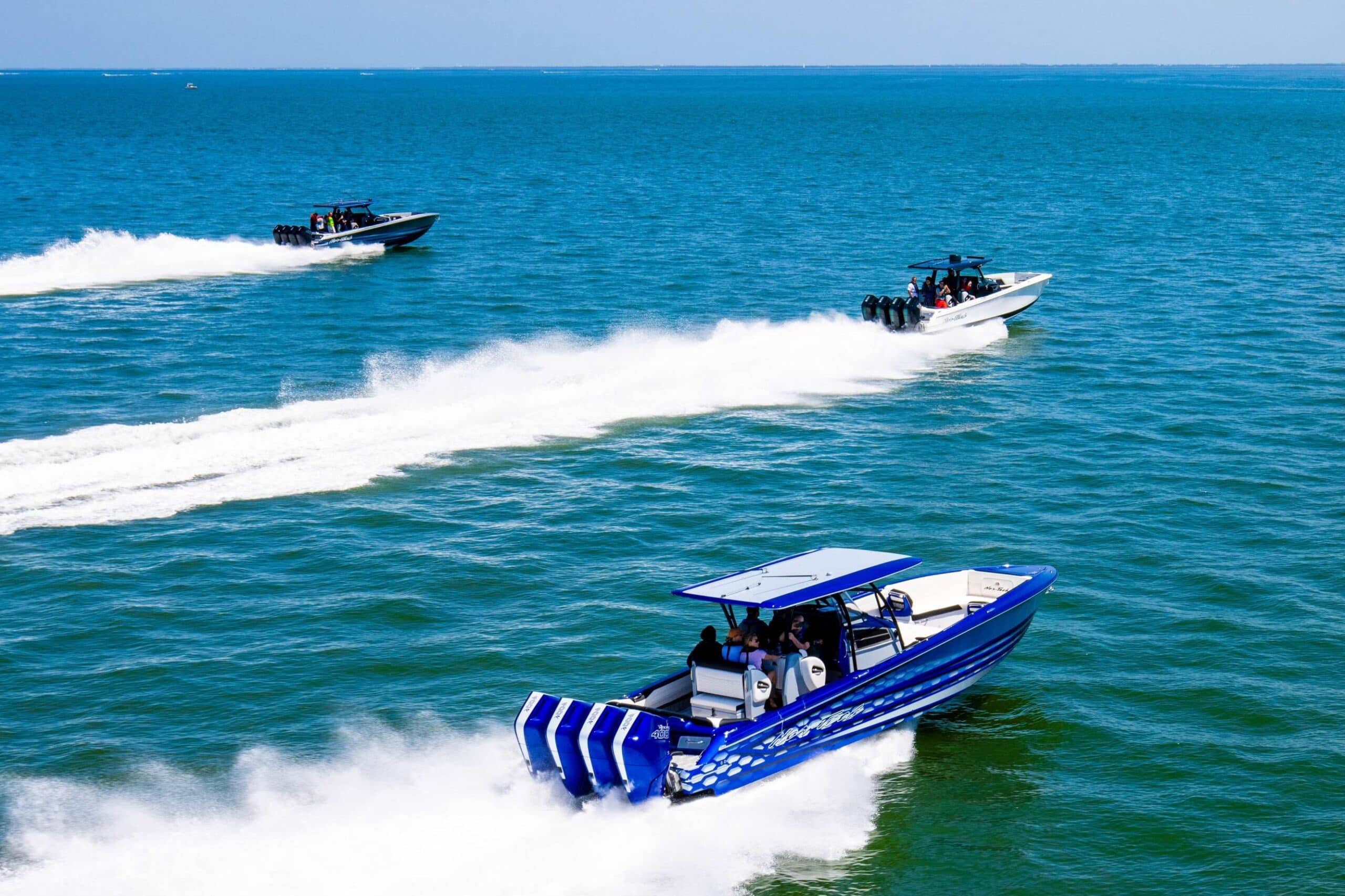 Three Sport Boats Cruising the Ocean